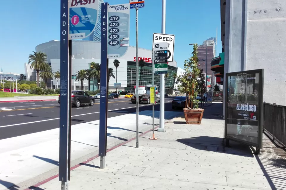 Bus stop in downtown Los Angeles with billboard and no bench or shelter